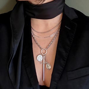 May include: A set of three ceramic mugs with a speckled, matte finish. The mugs are in shades of cream, light brown, and dark brown. Each mug has a simple, minimalist design, perfect for coffee or tea.