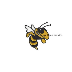 May include: An embroidered patch featuring a yellow and black bee with white wings and two antennae. The bee is depicted in a flying pose with a determined expression. The text "applique for kids" is printed in black to the right of the bee.