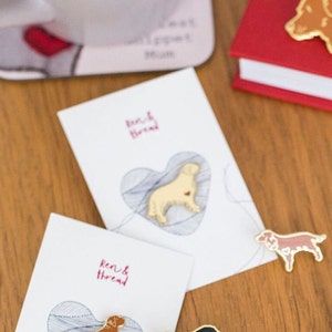 a collection of dog themed enamel pins by Ren and Thread