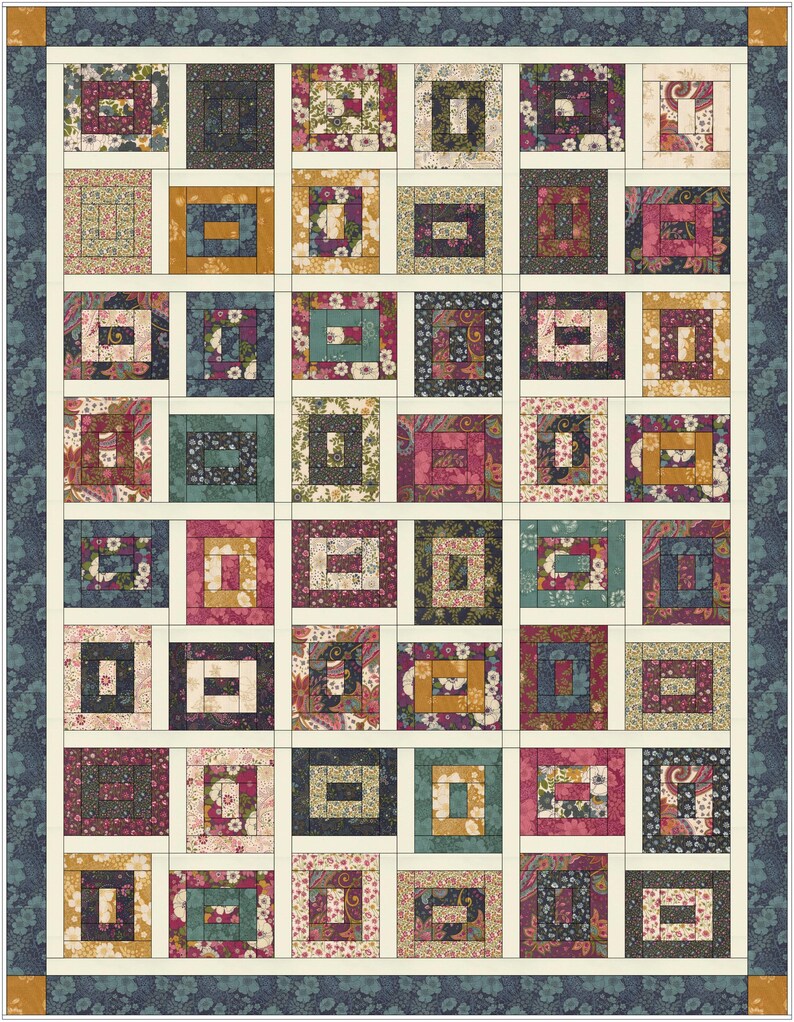May include: A rectangular quilt featuring a grid of block patterns in various floral and paisley prints. The colours include shades of deep blue, mustard yellow, magenta, and cream. The quilt is framed by a dark blue floral border with corner accents.