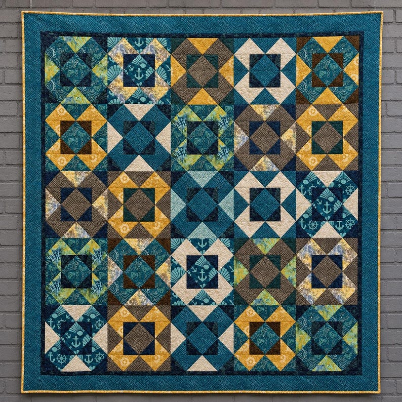 May include: A square quilt featuring a grid of alternating blocks in shades of teal, navy blue, mustard yellow, and brown. The design incorporates geometric patterns and nautical motifs, including anchors and ship wheels, finished with a teal border.