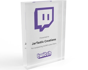 May include: A clear acrylic plaque with a purple Twitch logo and the text "Presented to JarTastic Creations For surpassing 10,000 subscribers twitch"