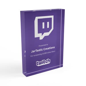 May include: Purple acrylic award plaque with a white Twitch logo and the text "Presented to JarTastic Creations for surpassing 10,000 subscribers".