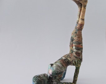 Figurative sculpture, a woman practicing yoga