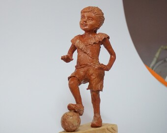 A girl playing with a ball, paper mache sculpture