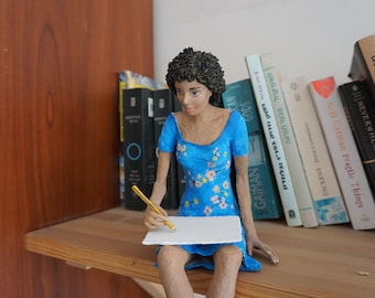 Paper mache sculpture, woman sitting and drawing