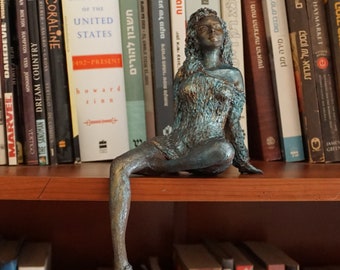 Paper mache sculpture, woman sitting and thinking,day dreaming