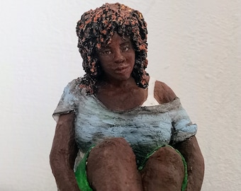 Paper mache sitting woman