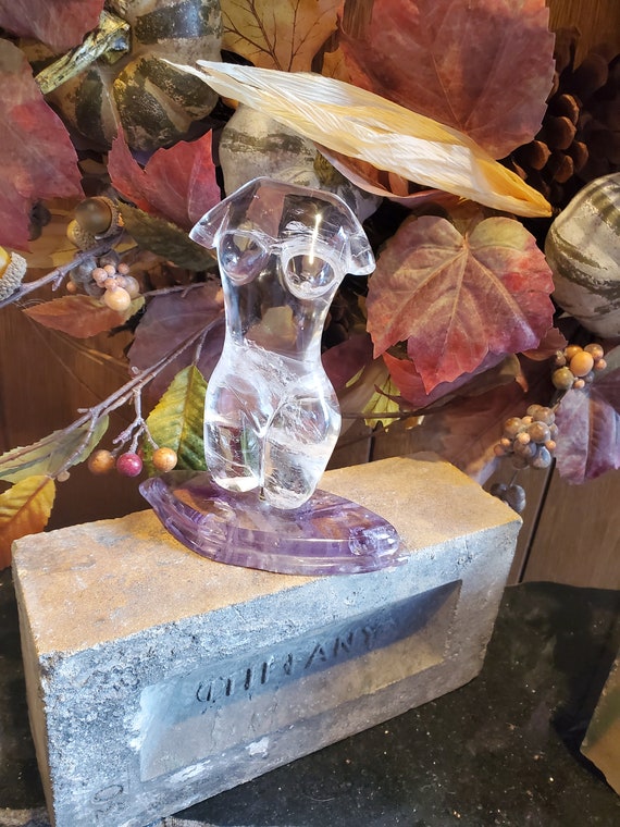 Carved Rock Crystal Nude seated on an Amethyst bas