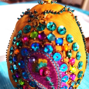 Ornaments hand made, hand beaded and hand wrapped in satin ribbon with a Paisley motif available in eight colors and 2 sizes. Originals Gift