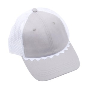 May include: A grey and white baseball cap with a scalloped brim. The cap has a mesh back panel.