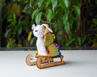 Sledding Snail figurine in a Santa hat with Christmas lights