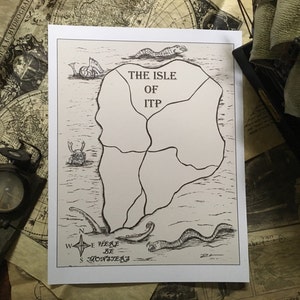 May include: A black and white map titled "The Isle of ITP" with illustrations of sea creatures. A compass and a model ship are visible in the background. The map includes the text "Here Be Monsters".