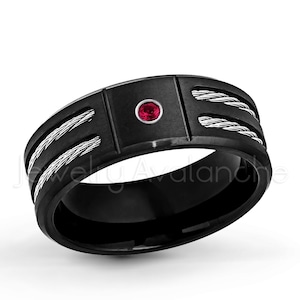 May include: Black tungsten carbide ring with a red gemstone and two silver cable accents.