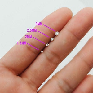 May include: Five clear round cubic zirconia stones of different sizes, ranging from 1.5mm to 3mm, are displayed on a finger. The stones are labeled with their size in millimeters.