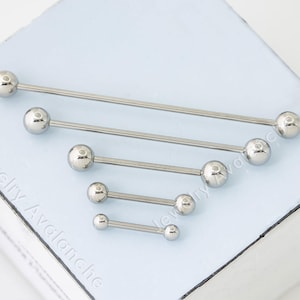 May include: Five different sizes of surgical steel barbell piercings. The barbells are all silver and have ball ends.