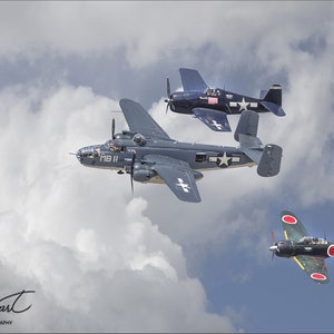 May include: Three vintage military aircraft flying in formation against a cloudy sky. A gray bomber with the markings "MB II" is in the center, a dark blue fighter plane with a white star is above it, and a green and red fighter plane with the markings "X-100" is below it.