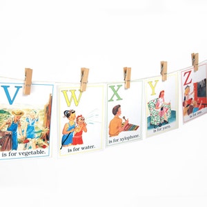 May include: A set of alphabet flashcards with illustrations and the letter and word for each letter. The letters are V, W, X, Y, and Z. The illustrations include a child picking vegetables, a child watering a plant, a child playing a xylophone, a child knitting yarn, and a child playing a musical instrument.