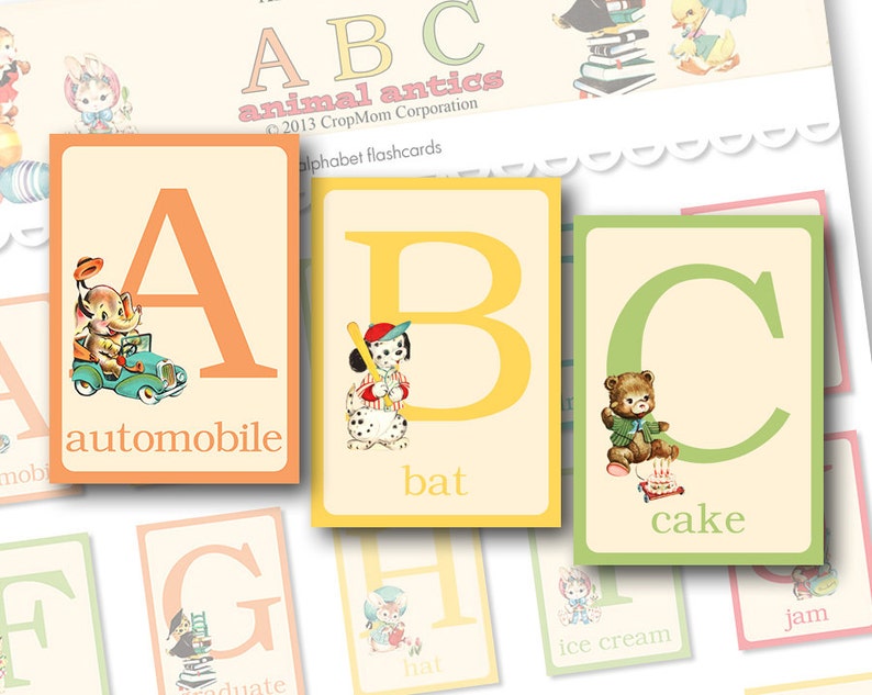 May include: A set of alphabet flashcards featuring colorful illustrations of animals and objects. Each card has a large letter, a picture, and a word. The letters are A, B, and C. The words are automobile, bat, and cake.