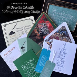 May include: A collection of stationery items including a framed quote, a certificate for the Haunted Inkbottle Literary and Calligraphy Society, envelopes with marbled liners, bookmarks, and cards featuring calligraphy and printed text.