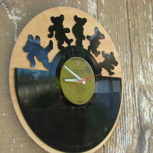 May include: A set of three ceramic nesting bowls in graduating sizes. The bowls are white with a blue floral pattern and a scalloped edge. The largest bowl measures 8 inches in diameter.