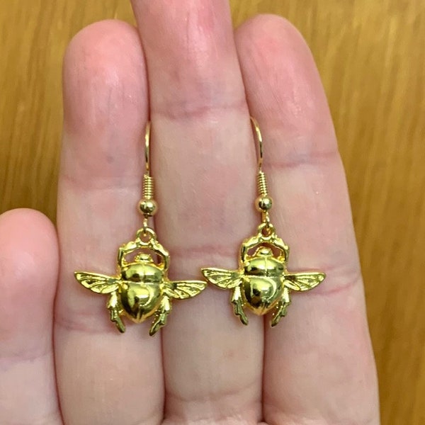 The Cave of Wonders gold bug key earrings