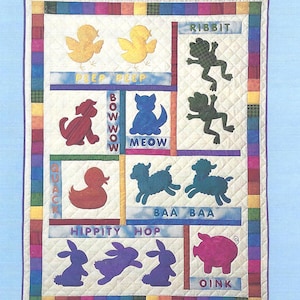 May include: A quilt pattern named "Animal Crackers" with appliquéd animal shapes. The design includes yellow chicks, a red duck, blue cats, green frogs, sheep, purple rabbits, and a pink pig. The text includes "PEEP PEEP", "BOW WOW", "MEOW", "BAA BAA", "HIPPITY HOP", and "OINK".