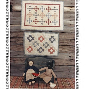 May include: An advertisement for miniature quilting patterns, folk dolls, and a settle bench. The image features two small quilts with geometric patterns, two folk dolls, and text that reads "QUICK-PIECED MINIATURES - I". The patterns include measurements of 14.5" x 20" and 11.5" x 16.5".
