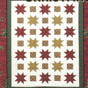 May include: A quilt pattern book titled Candy Coated Christmas by Thimbleberries featuring a quilt design with red and gold star blocks on a white background, framed by a dark green border, set against a red background with holiday text.