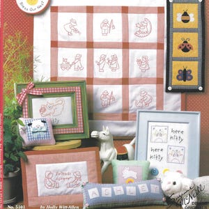 May include: A collection of framed redwork embroidery projects, including a framed cat, a framed design with the text "friends forever", and a pillow with the name "Ashley". The image also features a wall hanging with a bee, ladybug, and butterfly.