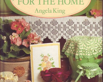 May include: Book cover with the title "55 Crochet Gifts for the Home" by Angela King. The cover features a crocheted tablecloth, a crocheted doily, and a crocheted jar cover.