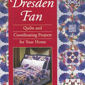 May include: Book cover with the title "Dresden Fan: Quilts and Coordinating Projects for Your Home" by Carolann M. Palmer. The cover features a purple and white quilt with a floral pattern and a red background.