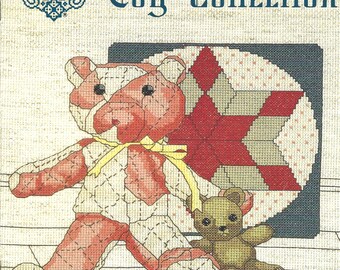 May include: Cross stitch pattern for a teddy bear and a quilt block with a red star. The pattern is titled "My Antique Toy Collection" and is designed by Gloria & Pat.