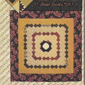 May include: A quilt pattern titled "Holiday Ties" by Kansas Troubles Quilters, designed by Lynne Hagmeier. The pattern is part of the KT Stash Society and is numbered #1243. The quilt features a central octagon surrounded by a series of concentric squares in red, black, and white.