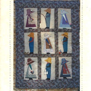 May include: A quilted wall hanging titled "Country Friends" featuring nine appliqued figures in a grid. Each figure is dressed in a hat and overalls, holding various items. The quilt measures approximately 21" x 24".