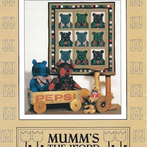 May include: A quilt pattern featuring nine patchwork squares with a bear wearing a bow tie in each square. The quilt is surrounded by a red, white, and blue border. The pattern is titled "Bowtie Bears" and is from "Mumm's The Word".