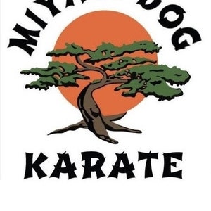 May include: Black and white logo with the text "Miyagi-Dog Karate" in a stylized font. A stylized bonsai tree with green leaves is in front of a red sun.