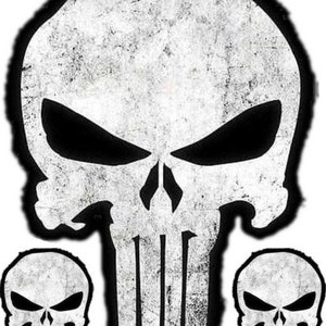 May include: A set of three white skull decals with a distressed, vintage look. The skulls have a black outline and a black eye socket.