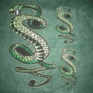 May include: A green and black snake design with intricate details. The snake is curled up in a coil with its head raised. The design is on a green background.