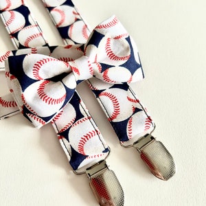 May include: A pair of blue and white suspenders with a baseball pattern and silver clips. A matching bow tie with the same pattern is included.