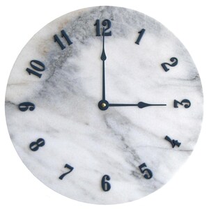 May include: A white marble clock face with black Roman numeral hour markers and black hands. The clock face has a gray marbled pattern.