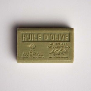 May include: A green bar of olive oil soap with the text "HUILE D'OLIVE" and "AU BEURRE DE KARITÉ BIO" in white. The soap also has the text "AVERAL" and "1985" in white.