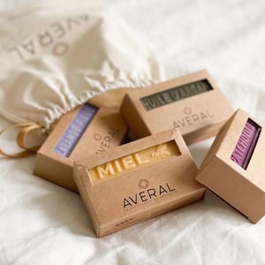 May include: Four bars of natural soap in cardboard boxes. The soaps are labeled "Miel", "Huile d'argan", "Lavande", and "Aloé Vera". Each box has the brand name "Averal" printed on it.