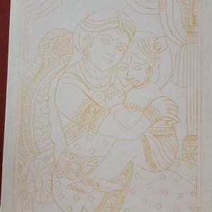 May include: Line drawing of a mother and child, possibly a depiction of the Hindu goddess Yashoda and baby Krishna. The drawing is done in gold ink on a white background.