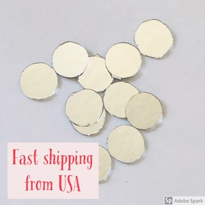 May include: A pile of round, silver-colored, decorative mirror tiles.  The tiles are scattered on a white surface.  Fast shipping from USA.