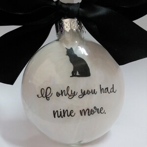 May include: White glass Christmas ornament with a black cat silhouette and the text "If only you had nine more."
