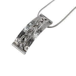 May include: A silver necklace with a hammered, curved pendant featuring a braided design.