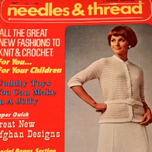 May include: A vintage magazine cover titled "needles & thread" with a red background. The cover features a woman wearing a white knit cardigan and skirt. The magazine's headline promotes new fashions for knitting and crochet.