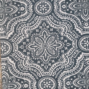 May include: A dark blue fabric with a white paisley pattern. The pattern features intricate details and a repeating design.