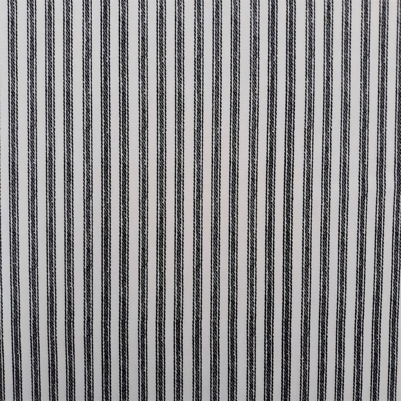 May include: White fabric with thin black stripes. The fabric has a subtle texture.